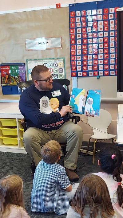NSLS member Elton Dean from Post University shares his children's book about autism with a local class