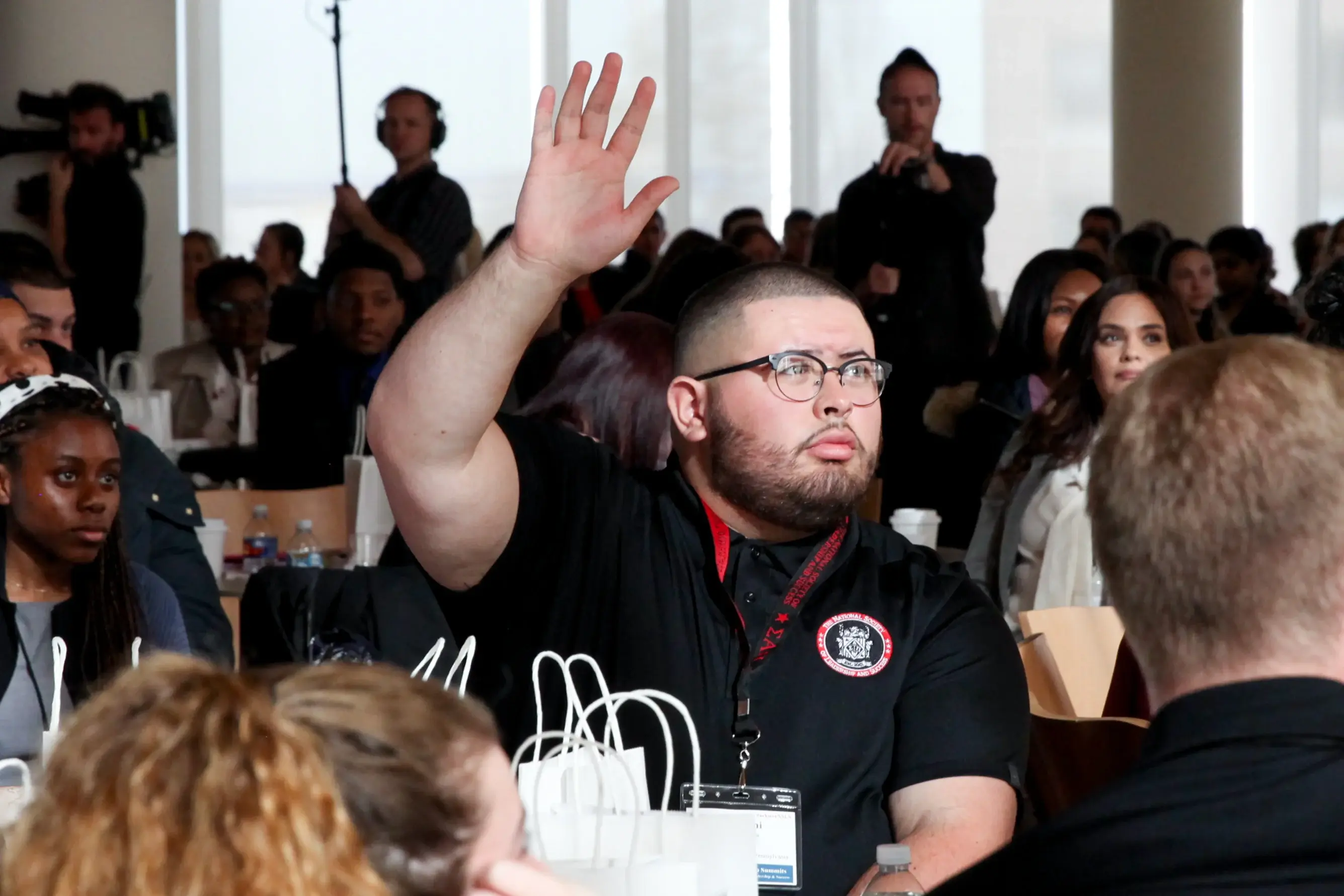 NSLS Employee Raising Hand at Conference.