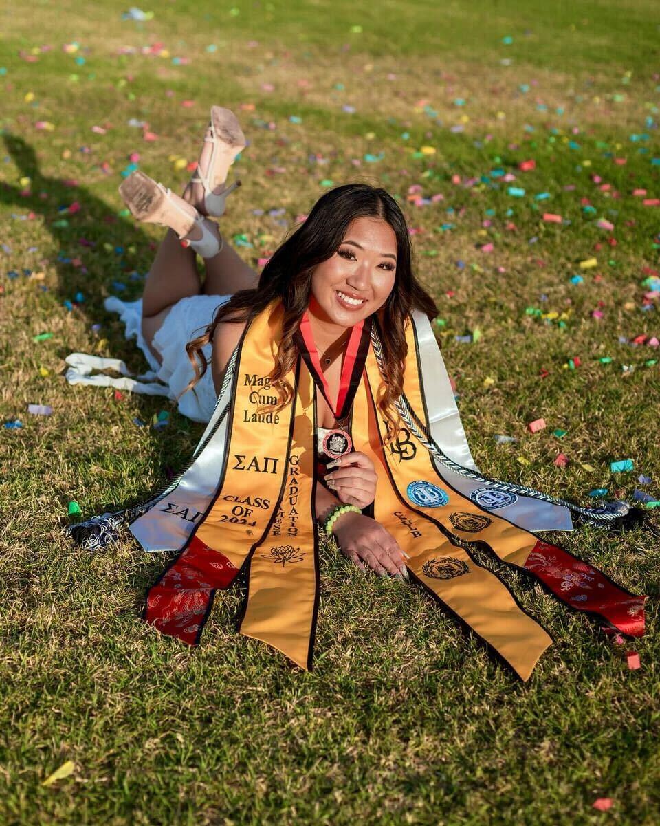 NSLS Student Wearing Graduation Regalia.