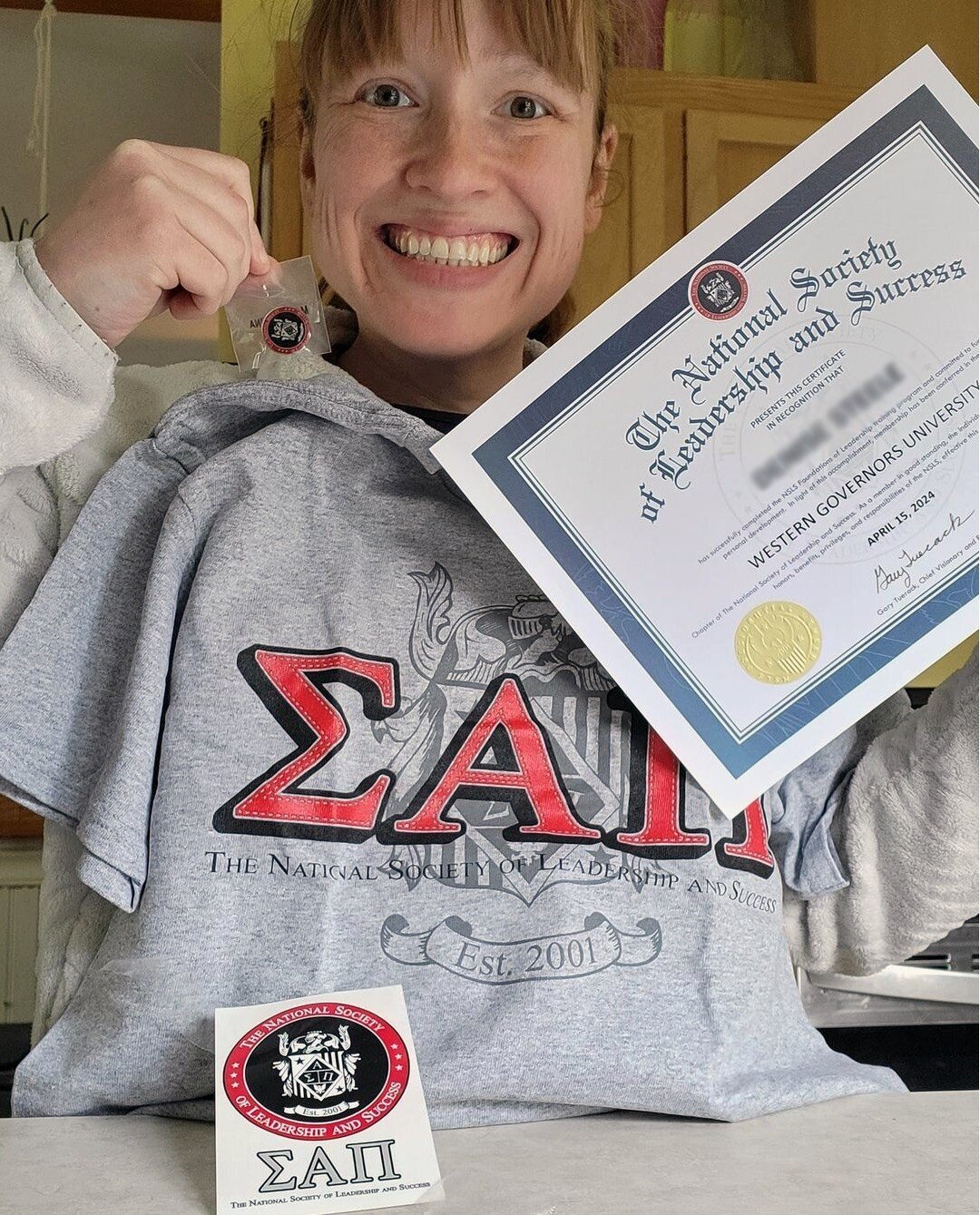 NSLS Inducted member showing off her induction certificate and membership kit